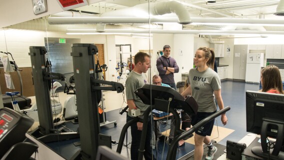 Other students watch as an Exercise Science student walks on a treadmill.