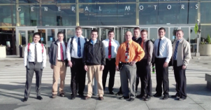 A group of students pose in front of a building while on an engineering technology career expedition