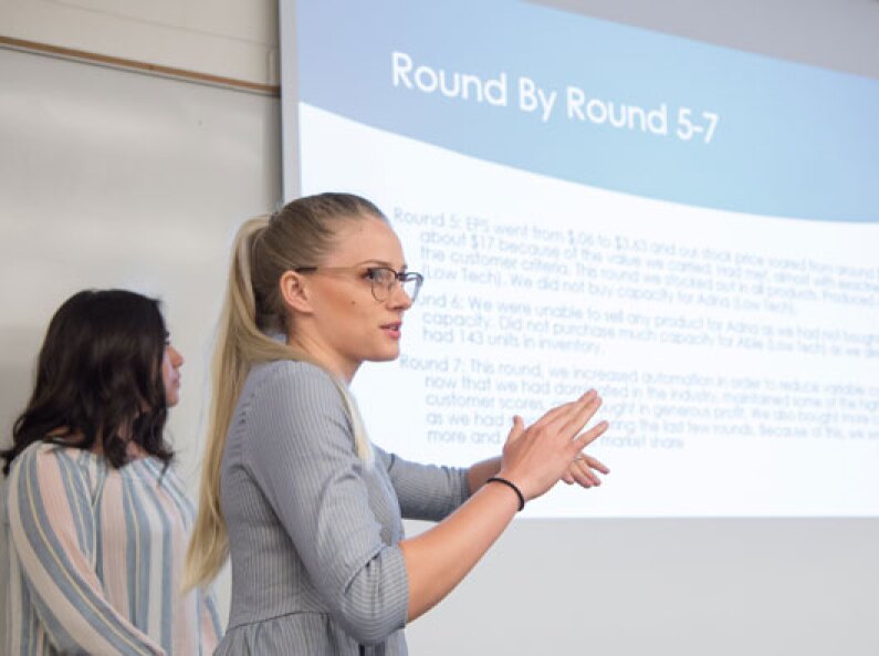 A student gives a presentation in Business Analytics.