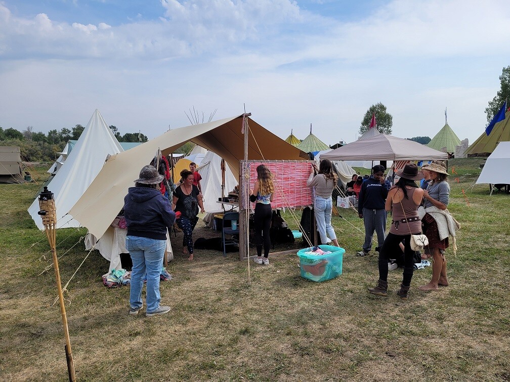 Group of people at a tent.