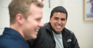 Two students talking and smiling