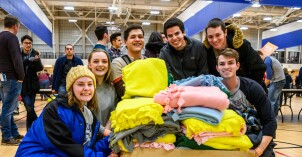 As part of the Get Connected experience students have the opportunity to serve by either writing notes to military members, making fleece blankets, making plastic yarn for mattresses, and more.
