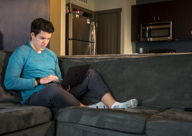 Cole Lewis, studying online at his apartment.