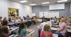 Students sit in their Foundations Religion class and take notes.