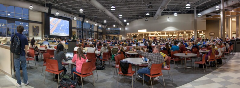 A panorama view of the MC Crossroads stage, the room is filled with people looking towards the stage.