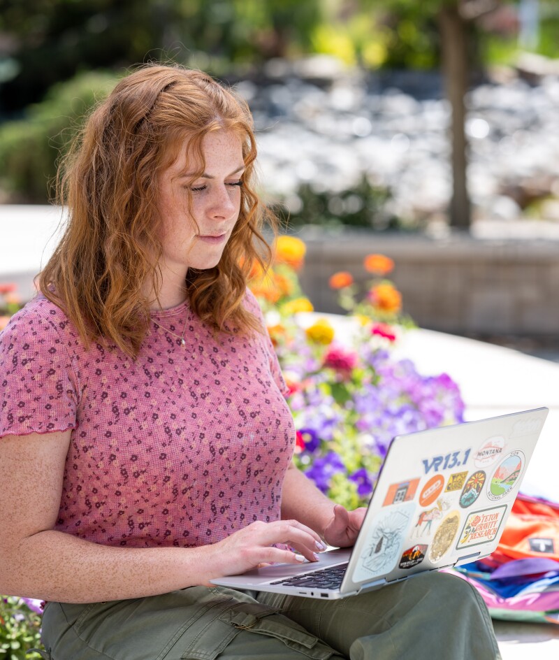 BYU-Idaho student sitting down working on her laptop