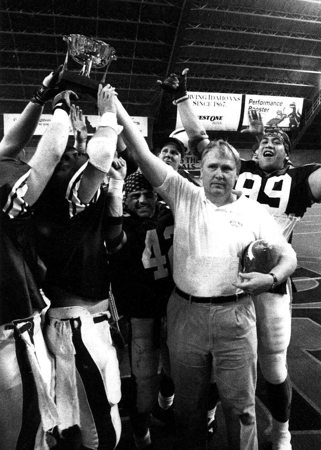 Coach Ron Haun celebrating with the Ricks College football players in 1992