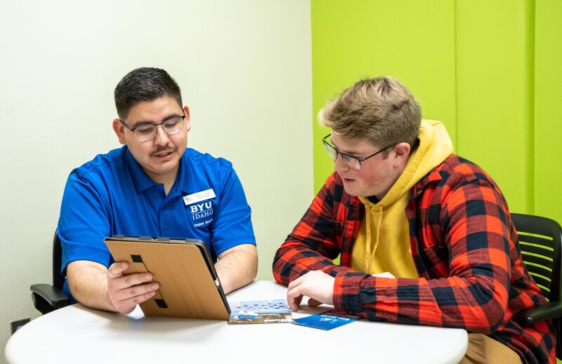 A peer mentor helping a fellow student