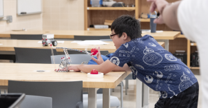 BYU-Idaho students lead robotics activity in the Romney Building at AstroFest.