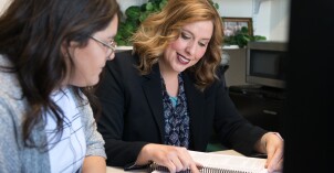 An advisor works with a student