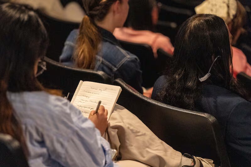 BYU–Idaho students listen and take notes during General Authority Seventy Elder David P. Homer's devotional message delivered in Rexburg, Idaho, on May 20, 2025.