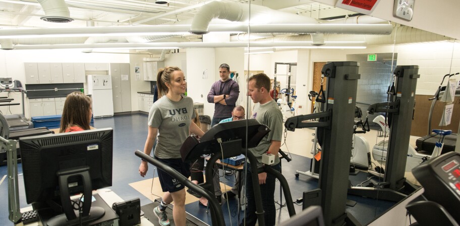 Other students watch as an Exercise Science student walks on a treadmill.