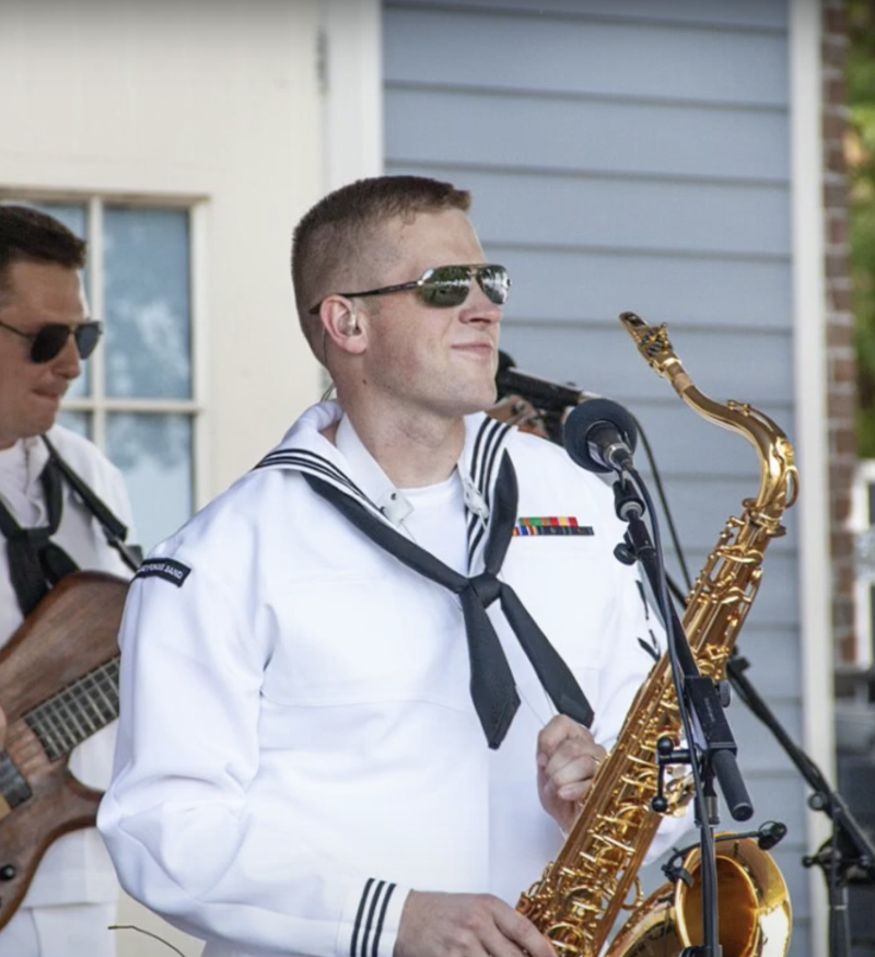 Kent Grover plays a saxophone with a military band.