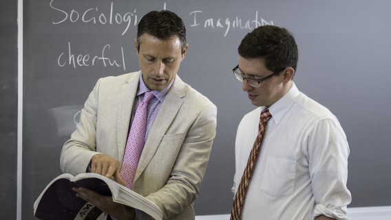 Stephan Smith, a sociology instructor, helping a student understand a new concept.