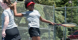 Girls playing tennis.