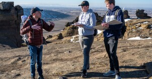 Geology students on a field trip survey the land