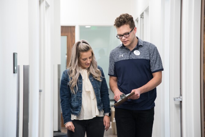 A BYU-Idaho Welness Center student employee coaching other student to achieve their goals towards health and wellness.