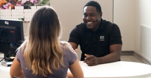 A student talking to an employee at the Career Center