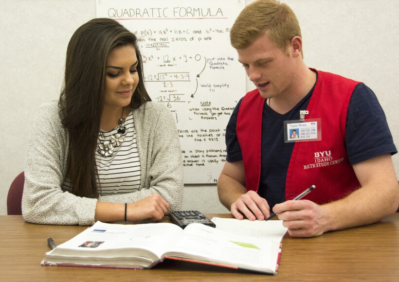 A math tutor helping a student with math homework