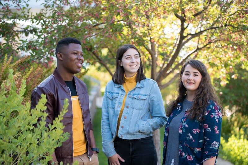 A small group of students smiling.