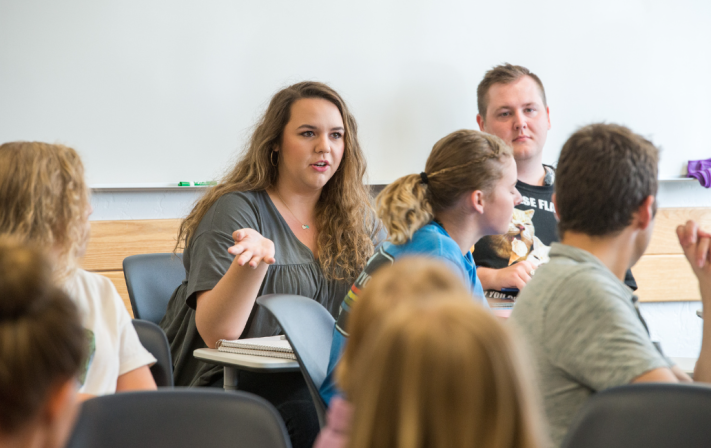 A marriage and family studies student discusses with the rest of class