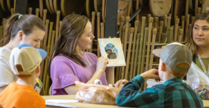 A family and consumer sciences student discusses with classmates and children