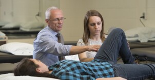 A professor teaches students with hands on experiences in the classroom.