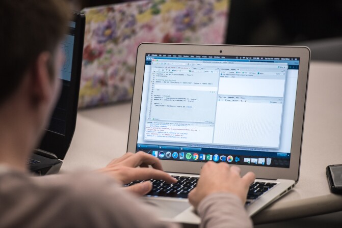A student learns about Data Wrangling on his computer.