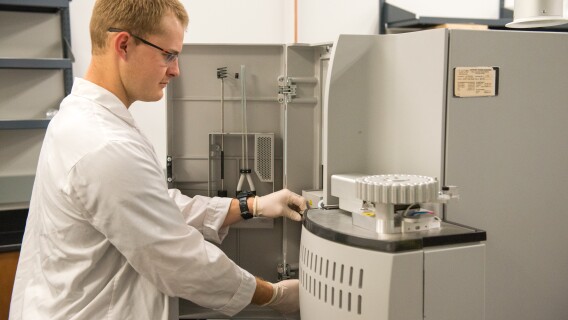 A male food Science student working with machines in the Instrument Room.