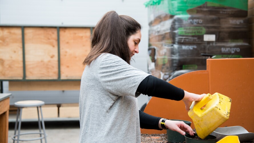 Student putting soil in pots