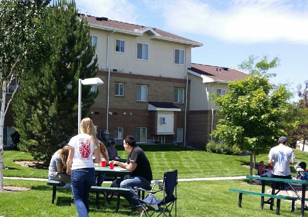 tenants eating at the University Village picnic tables