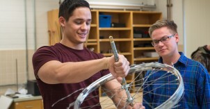 Physics students learn about rotational forces in a lab.