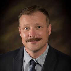 A professional photo of Department Chair Joshua Abegglen.