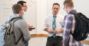 Math Education students talk with a professor.