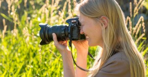 A photography student takes pictures in nature.