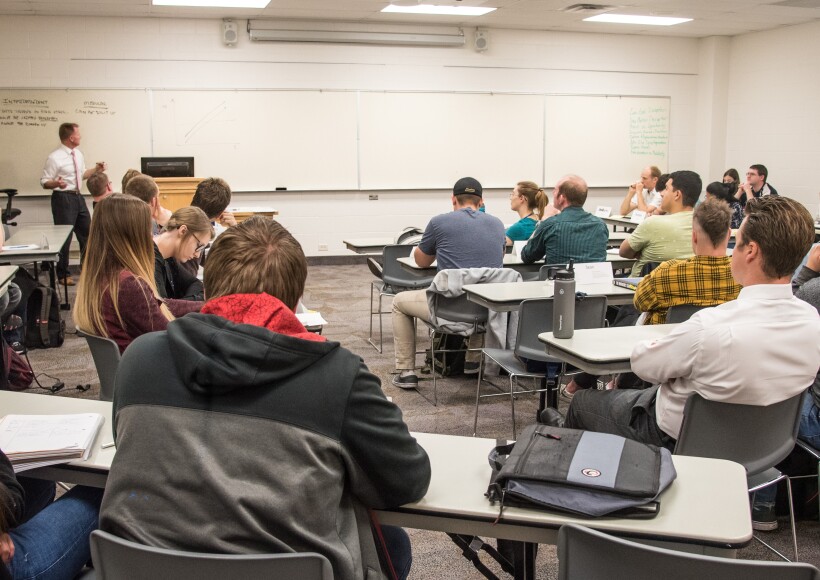 Professor Bill Crawford instructs students in a capstone Business Management course.