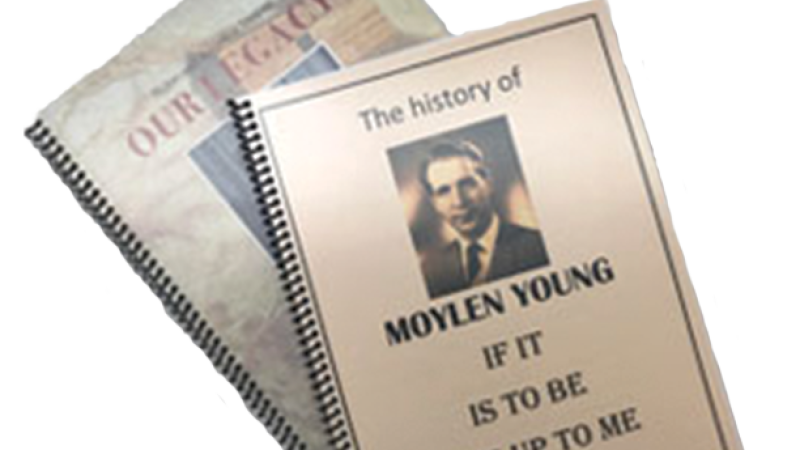 Two spiral-bound book on family history. One book reads "Our Legacy" and the other reads "The History of Moylen Young: If It is to Be, It is Up to Me."