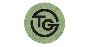 Teton Grill Logo "TG" written in black with gray/green swirl background.