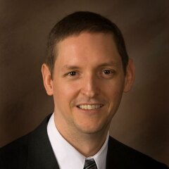 A professional photo of Dean Brian Memmott.