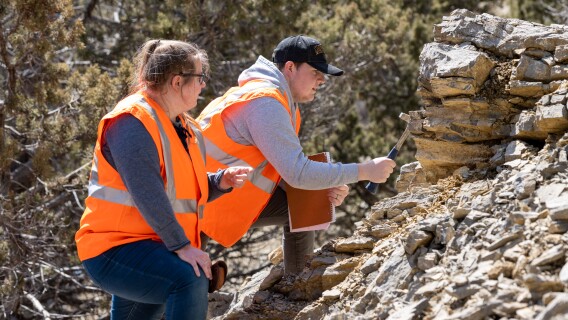 Students on a Geology class field trip study rocks at Kelly Canyon.