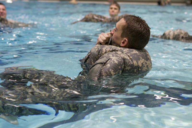 Cadets' doing water survival training with there uniforms on.
