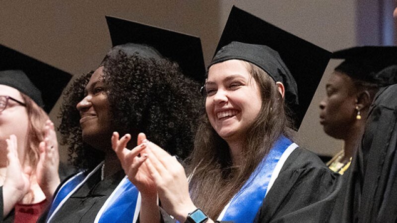 Group of graduates smiling and clapping