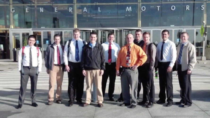 A group of students pose in front of a building while on an engineering technology career expedition