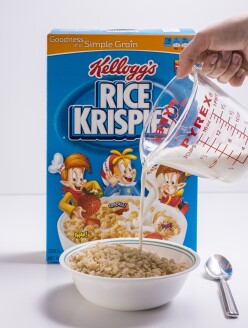A bowl of Rice Krispie cereal in front of the box