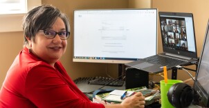 An online instructor holds an online class through Zoom.
