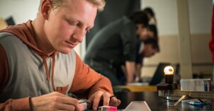 A student refracting lasers through differently shaped prisms.