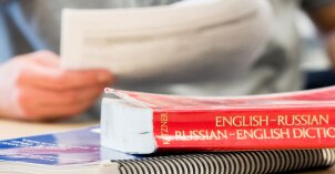 Student with language books on the desk.