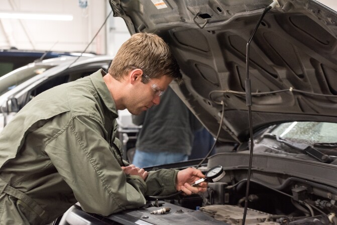 A student works on an engine in the Advanced Vehicle Systems Lab 3.