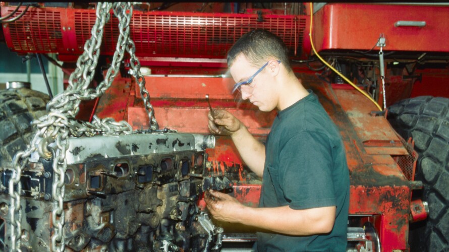 Agriculture student working on machinery