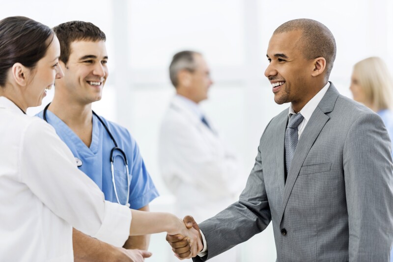 Businessman shaking hands with a doctor.